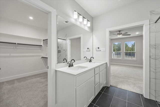 bathroom with ceiling fan, tile patterned floors, vanity, and walk in shower