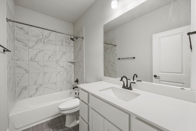 full bathroom featuring toilet, vanity, and tiled shower / bath