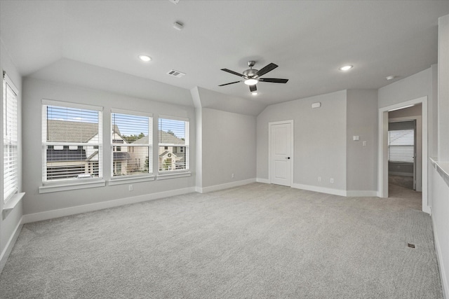 unfurnished room featuring lofted ceiling, light carpet, and ceiling fan