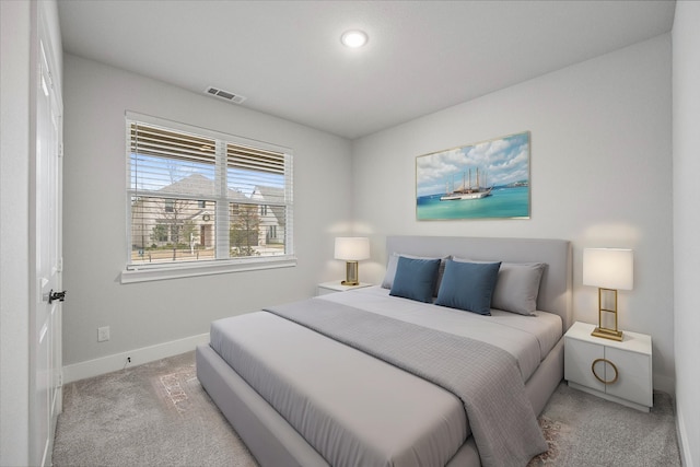 bedroom featuring light carpet