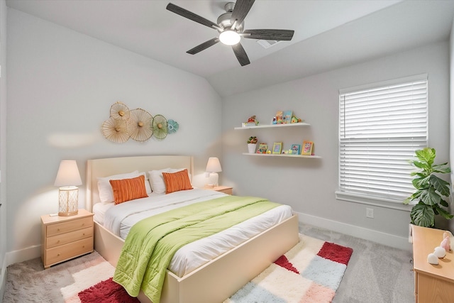 carpeted bedroom featuring ceiling fan and vaulted ceiling