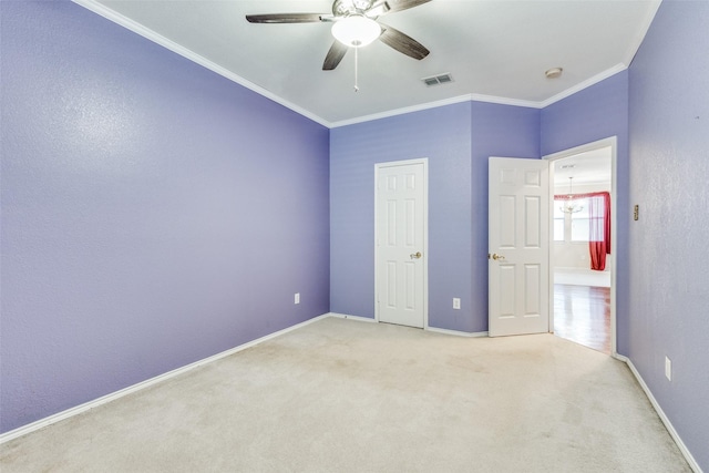 unfurnished bedroom featuring ornamental molding, visible vents, light carpet, and baseboards