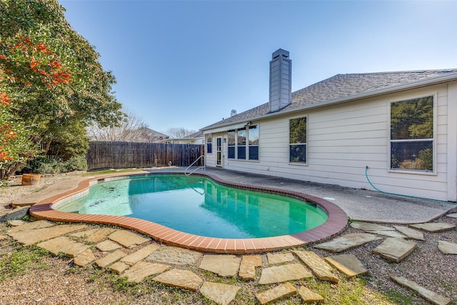 view of swimming pool featuring a patio, fence, and a fenced in pool