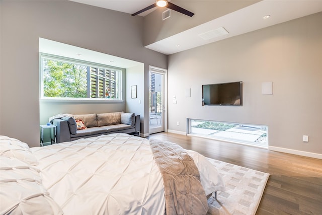 bedroom featuring ceiling fan, hardwood / wood-style flooring, and access to outside