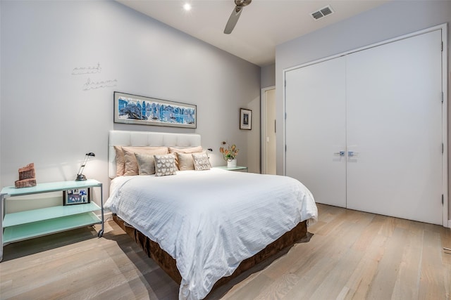 bedroom featuring light wood-type flooring, a closet, and ceiling fan