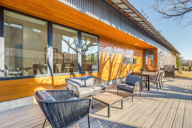 deck featuring area for grilling and outdoor lounge area