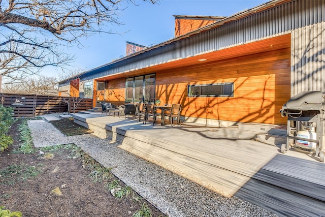 back of property featuring a wooden deck