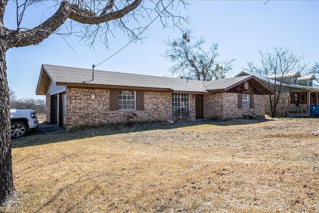 single story home with a front yard and a garage