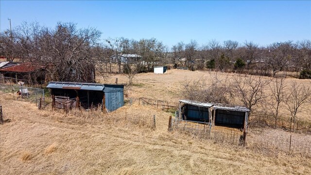 view of yard featuring an outbuilding and a rural view