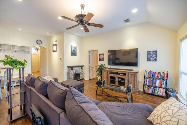 living room with ceiling fan, wood-type flooring, a fireplace, and lofted ceiling