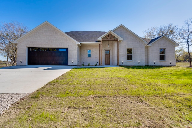 view of front of house with a garage and a front yard