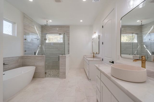 bathroom featuring vanity and separate shower and tub