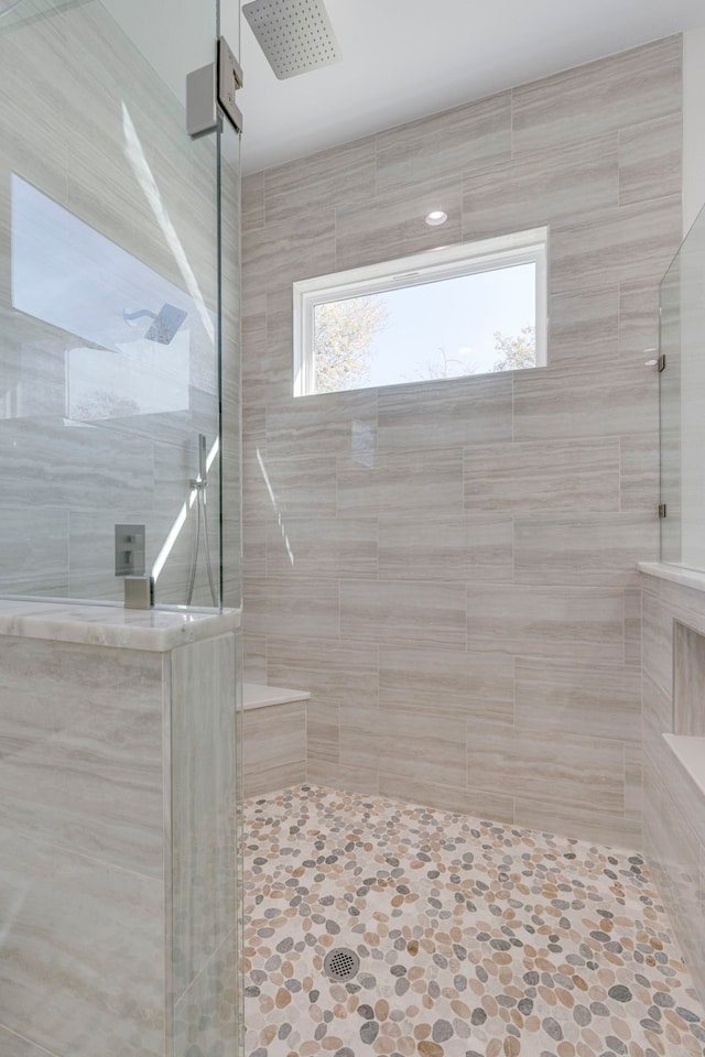 bathroom with a tile shower