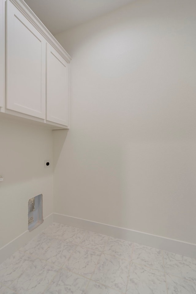 washroom featuring hookup for an electric dryer and cabinets