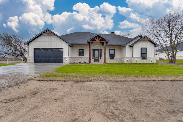 modern inspired farmhouse featuring a front lawn and a garage