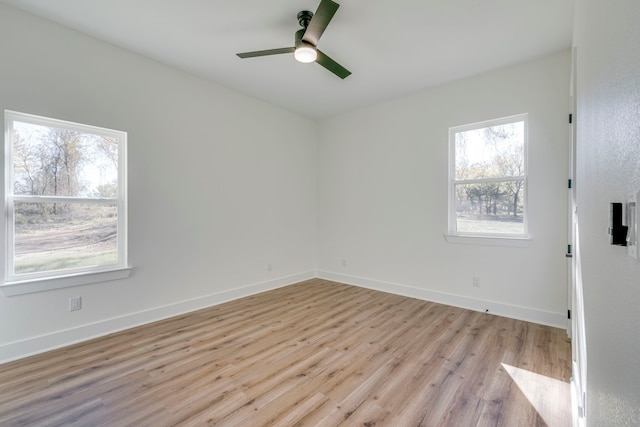 empty room featuring ceiling fan and light hardwood / wood-style floors