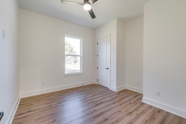 empty room featuring ceiling fan and light hardwood / wood-style flooring