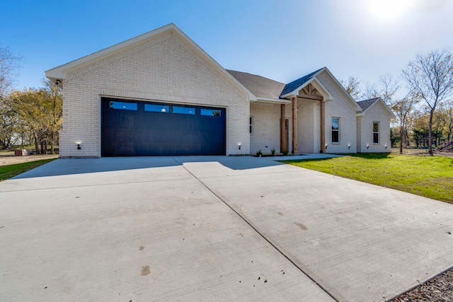 view of front facade with a front yard and a garage