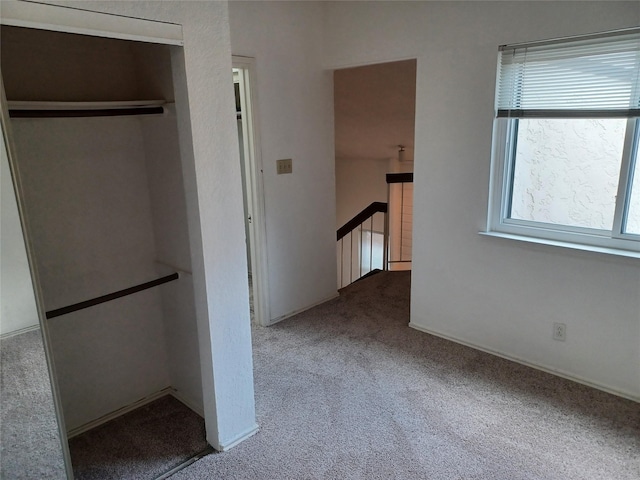 hall with light colored carpet