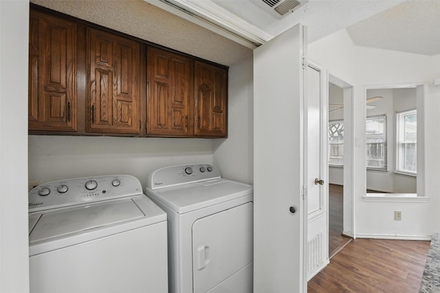 821 Dublin Dr Unit 203, Richardson, TX 75080 - laundry area with washing machine and dryer, cabinet space, wood finished floors, and visible vents