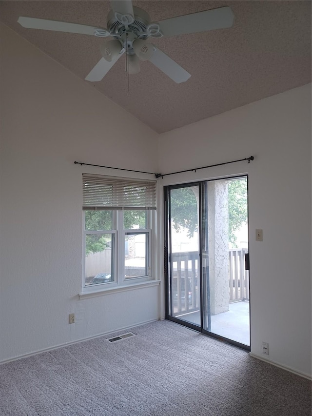 unfurnished room with carpet floors, a textured ceiling, lofted ceiling, and ceiling fan