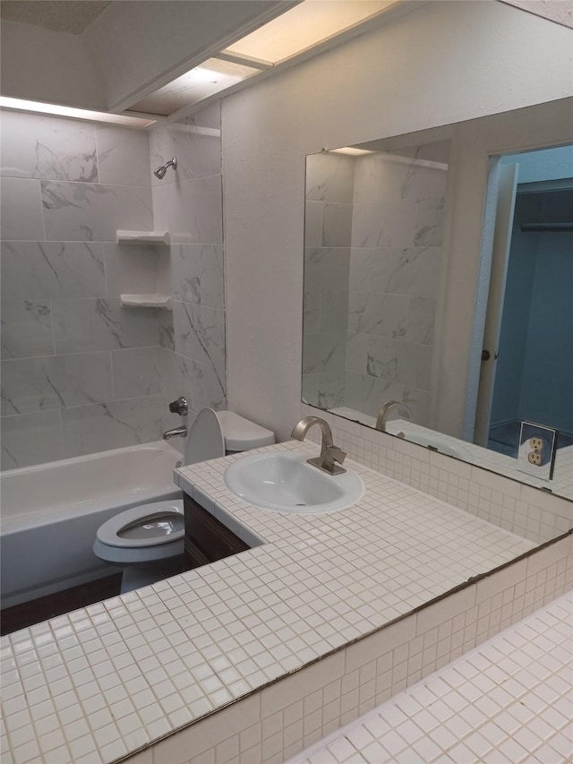 full bathroom featuring toilet, vanity, and tiled shower / bath combo