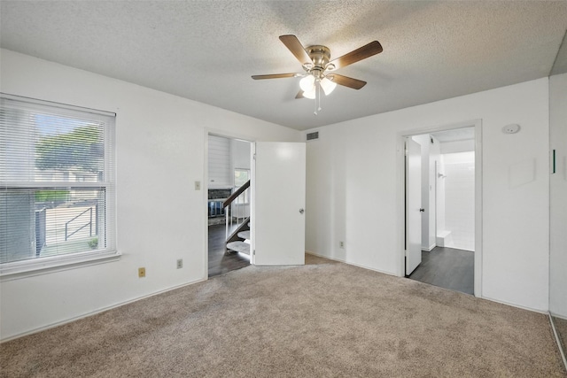 821 Dublin Dr Unit 203, Richardson, TX 75080 - unfurnished bedroom with visible vents, a textured ceiling, and carpet flooring
