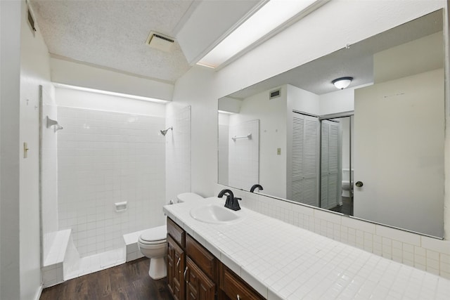 821 Dublin Dr Unit 203, Richardson, TX 75080 - bathroom featuring toilet, visible vents, walk in shower, a textured ceiling, and wood finished floors