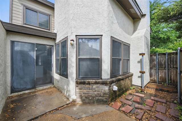 821 Dublin Dr Unit 203, Richardson, TX 75080 - view of exterior entry with fence and stucco siding