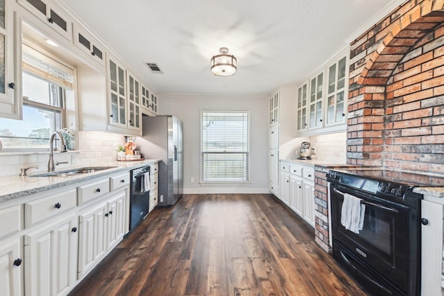 kitchen featuring white cabinetry, decorative backsplash, light stone countertops, black appliances, and sink