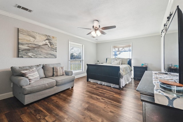 bedroom featuring ceiling fan, a barn door, ornamental molding, a textured ceiling, and dark hardwood / wood-style flooring