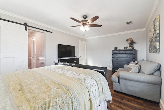 bedroom with ceiling fan, a barn door, dark hardwood / wood-style floors, ensuite bath, and crown molding