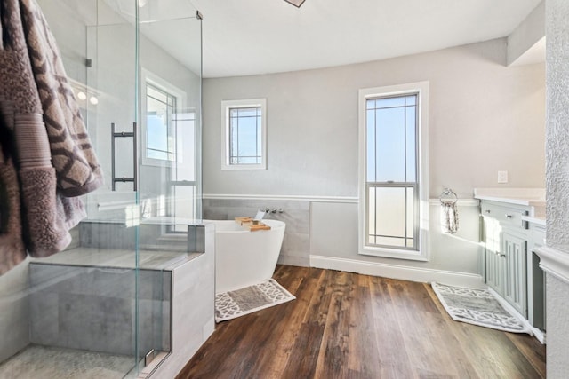 bathroom featuring independent shower and bath and hardwood / wood-style flooring