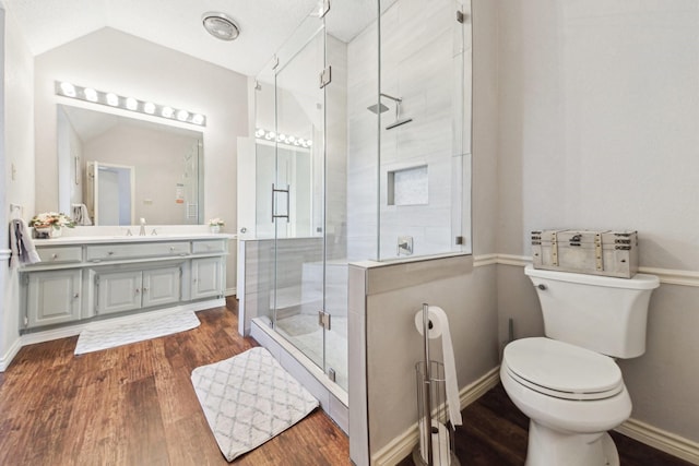 bathroom featuring vanity, toilet, walk in shower, vaulted ceiling, and hardwood / wood-style flooring