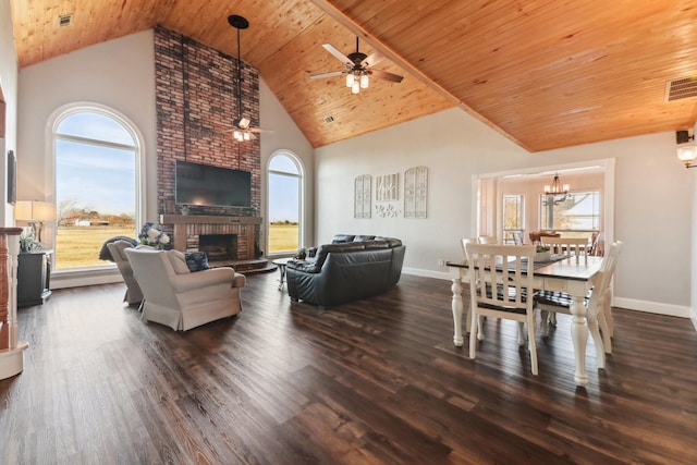 living room with high vaulted ceiling, a fireplace, ceiling fan with notable chandelier, and dark wood-type flooring