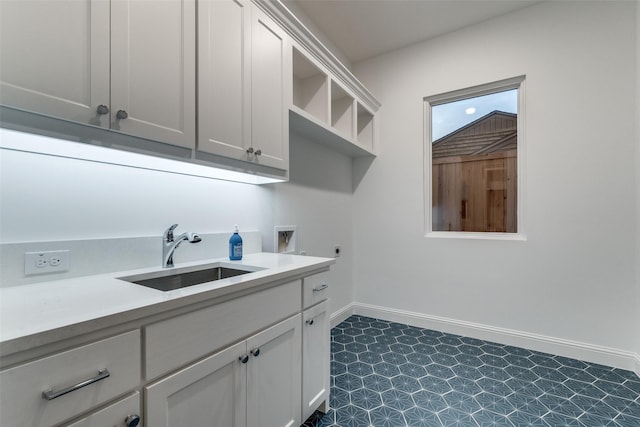 clothes washing area featuring cabinets, hookup for an electric dryer, hookup for a washing machine, and sink