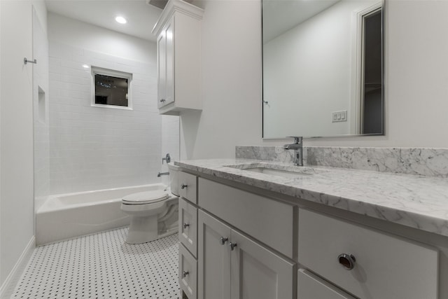 full bathroom featuring toilet, tiled shower / bath, and vanity