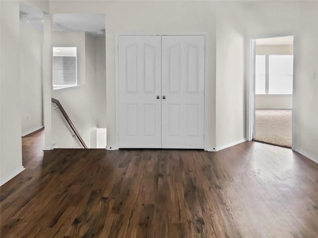 unfurnished bedroom featuring dark hardwood / wood-style floors and a closet