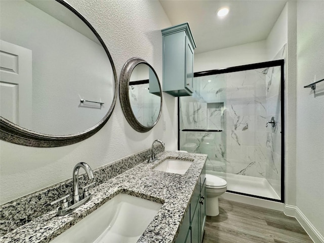 bathroom with toilet, hardwood / wood-style flooring, an enclosed shower, and vanity