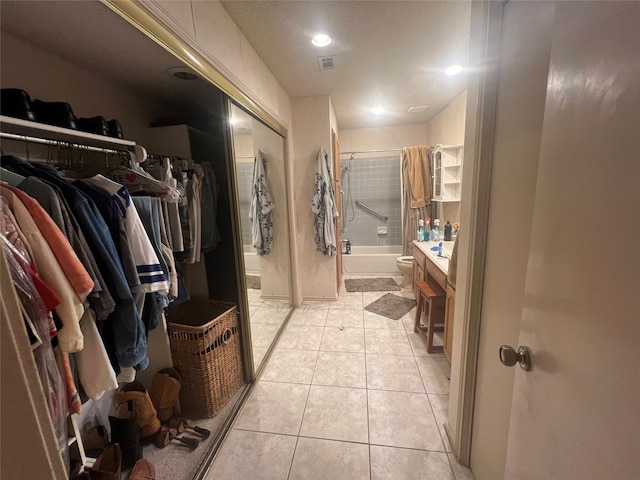 full bathroom featuring toilet, bath / shower combo with glass door, tile patterned flooring, and vanity