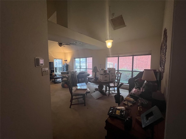 carpeted living room featuring a towering ceiling