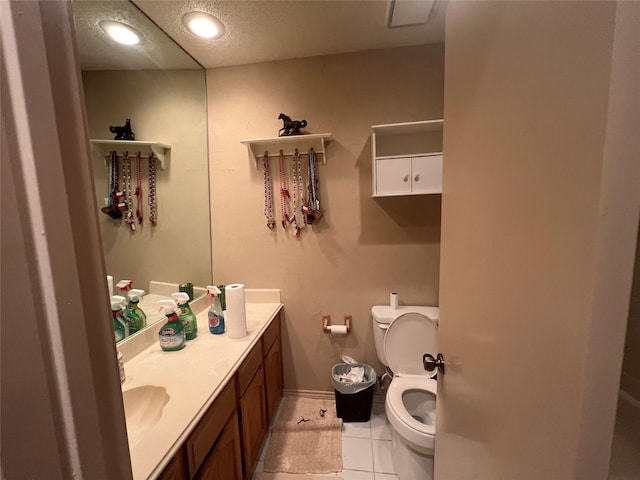 bathroom featuring toilet, vanity, and tile patterned floors