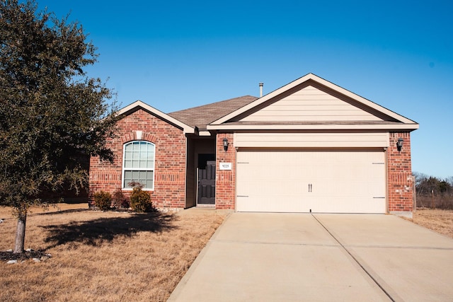 single story home featuring a garage and a front lawn