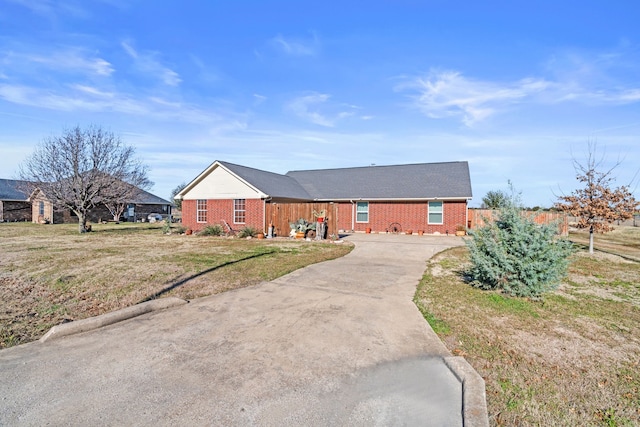 ranch-style home featuring a front yard