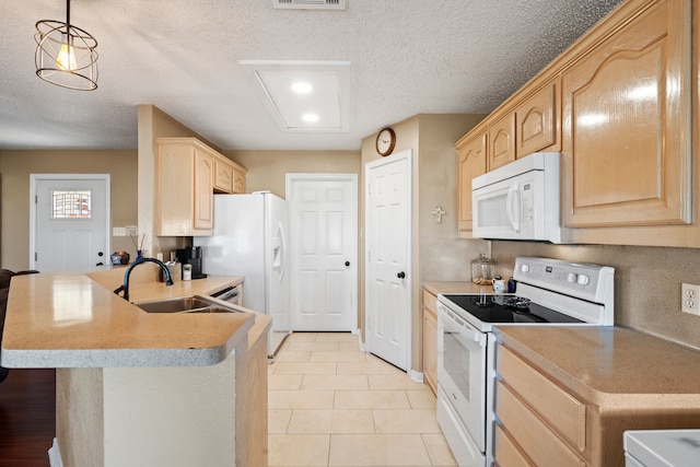 kitchen with light brown cabinetry, sink, hanging light fixtures, and white appliances