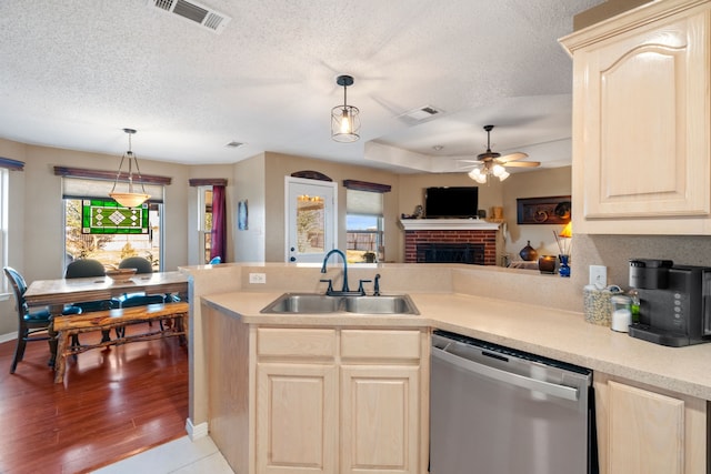 kitchen featuring decorative light fixtures, sink, a wealth of natural light, and dishwasher