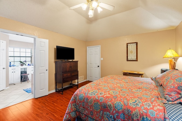 bedroom featuring ceiling fan, lofted ceiling, and light wood-type flooring