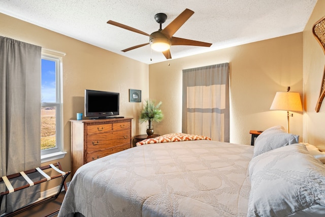 bedroom featuring a textured ceiling and ceiling fan