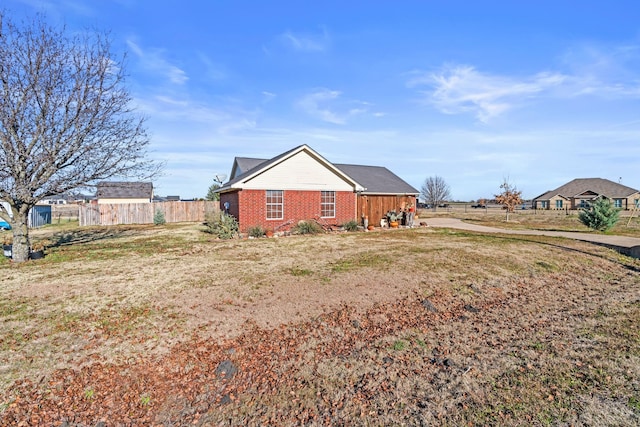 view of side of property with a lawn