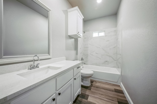 full bathroom featuring wood-type flooring, toilet, vanity, and tiled shower / bath